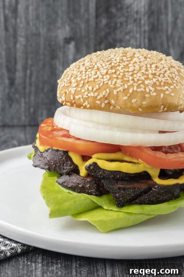 How to Smoke Bologna for Big Flavor at Home 3 crispy-edged bologna on a hamburger bun or great homemade sandwich bread with mustard or mayo, lettuce, tomato, and a slab of sweet onion.