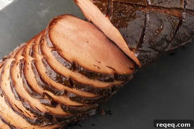 How to Smoke Bologna for Big Flavor at Home 5 crispy-edged bologna on a hamburger bun or great homemade sandwich bread with mustard or mayo, lettuce, tomato, and a slab of sweet onion.