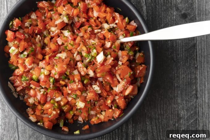 Criolla Salsa Recipe: Authentic Peruvian Onion & Tomato Sauce 4 Bowl of Salsa a la Criolla showing diced tomatoes, onions, and herbs.