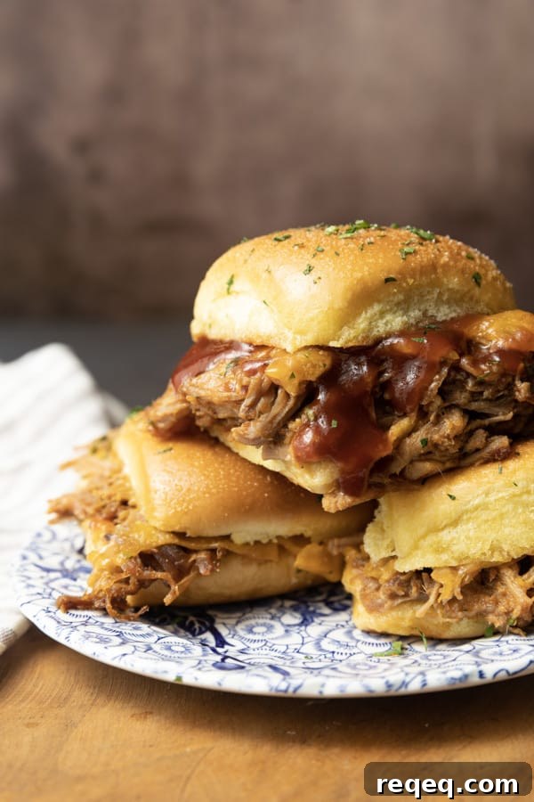 Smoky Pulled Pork Sliders with Tangy BBQ Sauce 4 Easy Pulled Pork Sliders: Pillowy rolls filled with delicious, mouth-watering, tender pulled pork, bbq sauce, and cheese are brushed with melted butter, garlic, and herbs, then baked to toasty, melty perfection. They’re like the little black dress of the sandwich world and perfect for every occasion. Bonus: They're done in 30 minutes from start to finish!