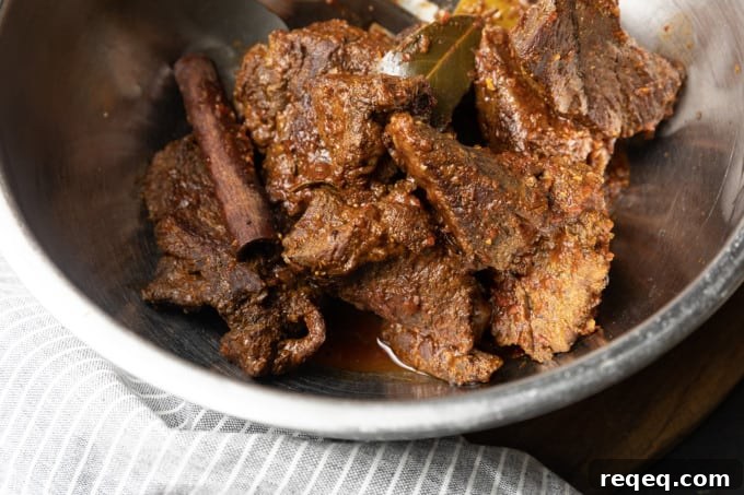Instant Pot Birria Tacos: Tender Meat in Rich Consommé 6 Shredded birria served in a bowl with consommé.