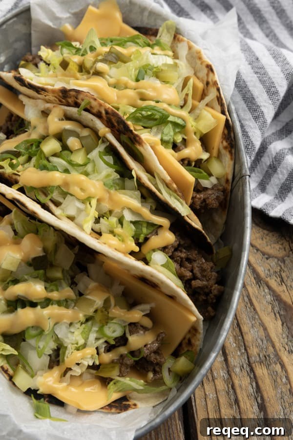 Big Mac–Style Tacos: Copycat Recipe for the Classic Flavor 5 Close-up of Big Mac Tacos showing layers of cheese, beef, lettuce, pickles, and sauce.