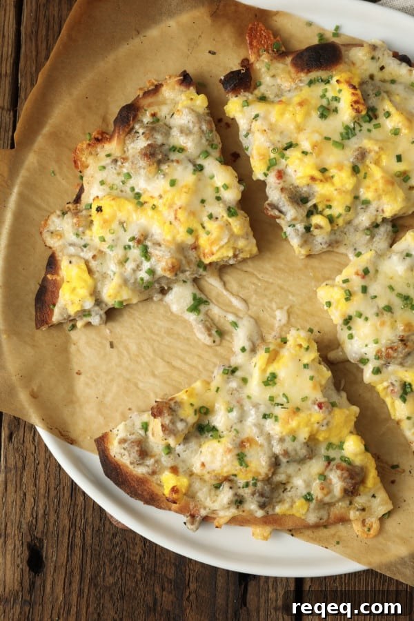 Sausage Gravy Breakfast Pizza on a chewy crust topped with scrambled eggs, sausage gravy, cheese, and chives.