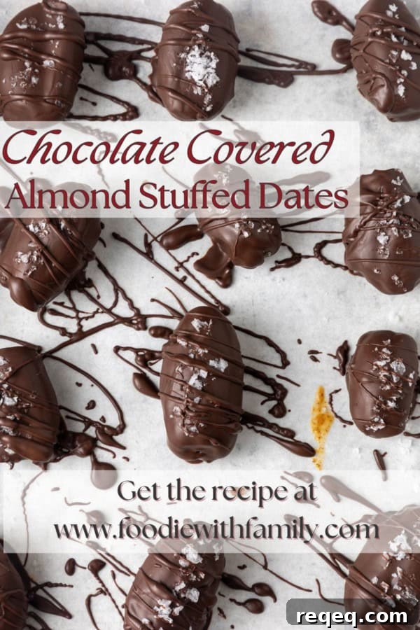 Chocolate-Covered Dates: Simple Recipe for Decadent Treats 9 chocolate covered almond stuffed dates with sea salt on parchment lined sheet pan with a text overlay describing the photo