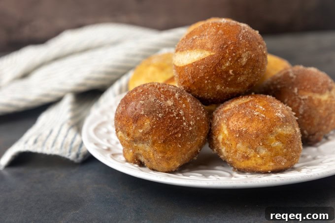 A plate of cinnamon sugar pretzel bites on a table with a napkin.