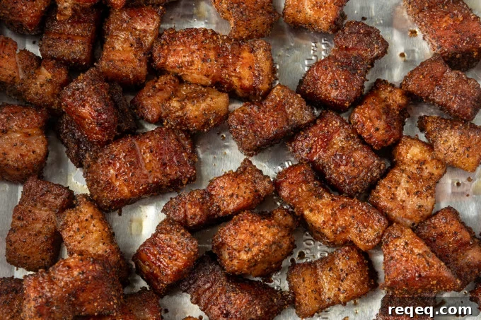 Crispy Pork Belly Bites Recipe: Savory Bite-Size Pork Treats 5 A cooling rack filled with pieces of meat.