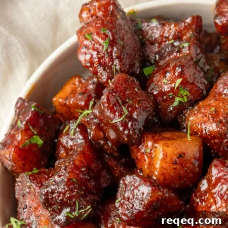 Crispy Pork Belly Bites Recipe: Savory Bite-Size Pork Treats 9 A pan filled with meat bites.