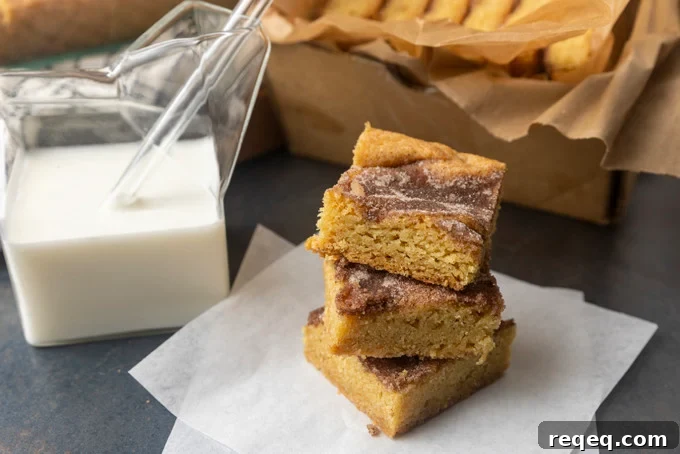 snickerdoodle cookie bars with a glass jar of milk