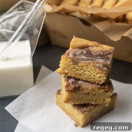snickerdoodle cookie bars with a glass jar of milk