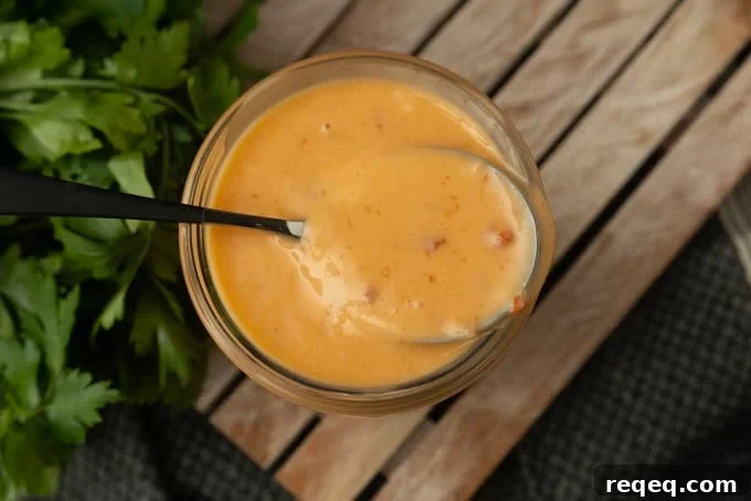 bang bang sauce in a jar with a spoon