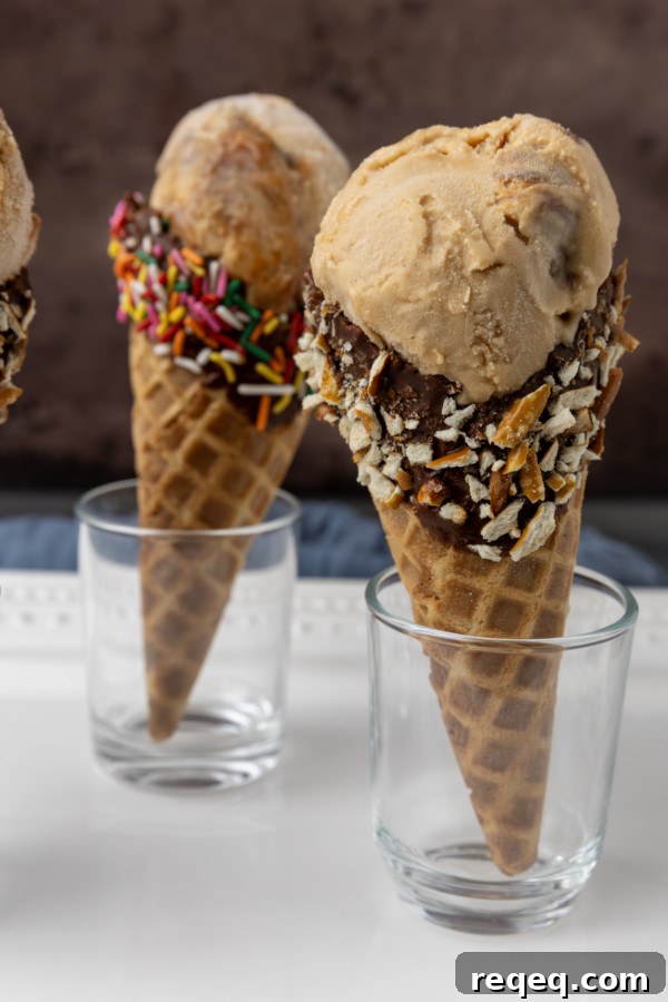 Creamy Dulce de Leche Ice Cream Recipe – Homemade Argentine Flavor 5 Three dulce de leche ice cream cones with toppings on them.