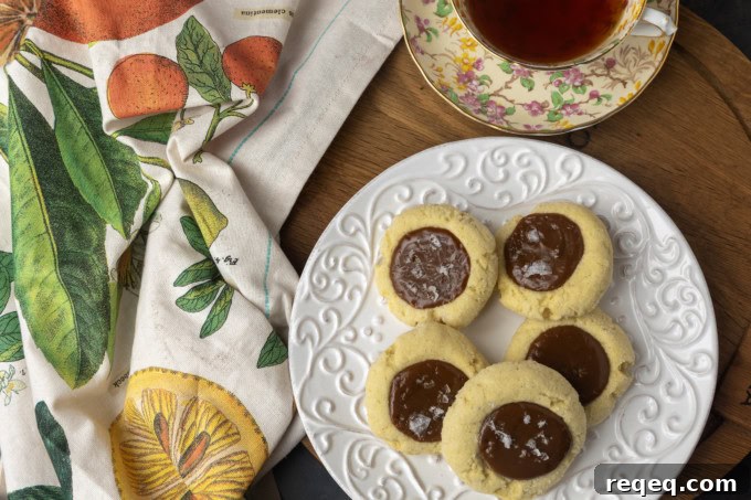 Dulce de Leche Cookie Recipe: Chewy Caramel Treats for Dessert 3 dulce de leche thumprint shortbread cookies on a plate