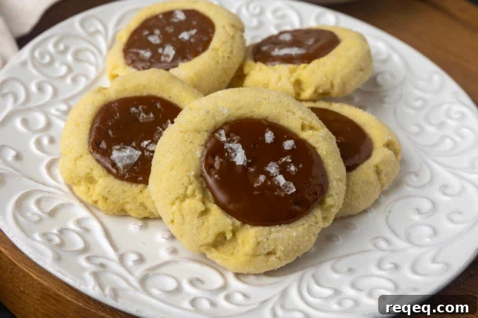 Dulce de Leche Cookie Recipe: Chewy Caramel Treats for Dessert 4 dulce de leche thumprint shortbread cookies on a plate