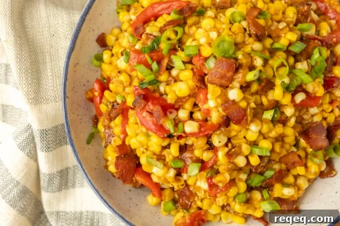 fried sweet corn with bacon, green onions and roasted red peppers in a bowl