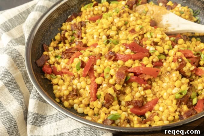 fried sweet corn with bacon, green onions and roasted red peppers in a bowl