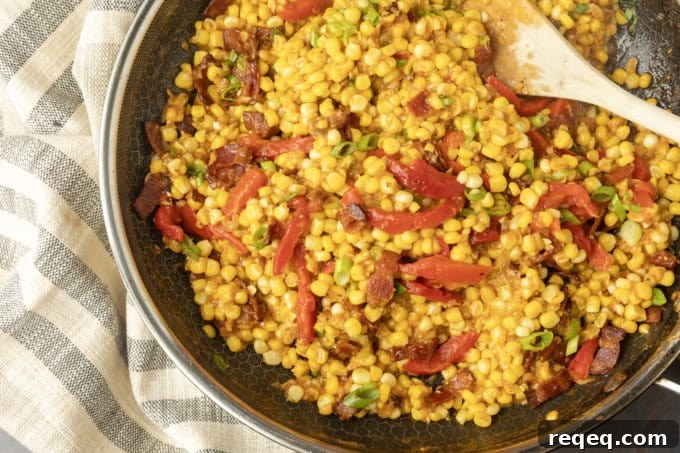 fried sweet corn with bacon, green onions and roasted red peppers in a bowl