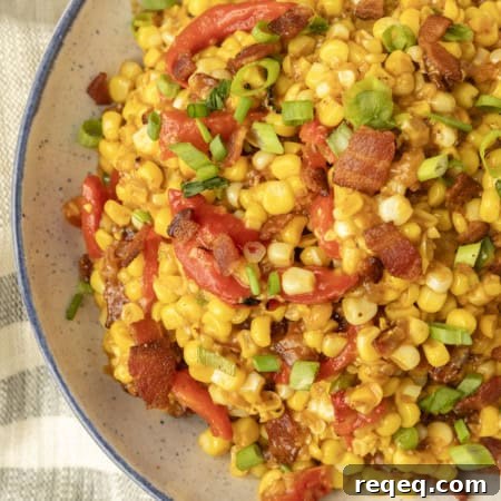 fried sweet corn with bacon, green onions and roasted red peppers in a bowl