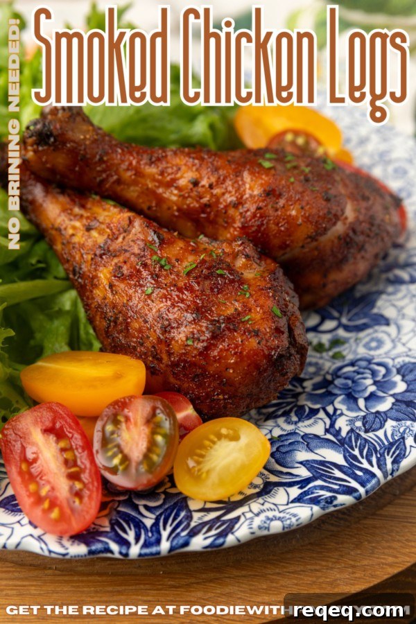 smoked chicken drumsticks on a blue and white plate with cherry tomatoes and text describing the photograph