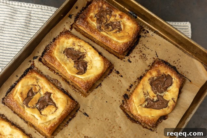 Flaky Cream Cheese Pastries: Quick Recipe for Homemade Treats 8 nutella cream cheese puff pastry with thyme on parchment lined pan