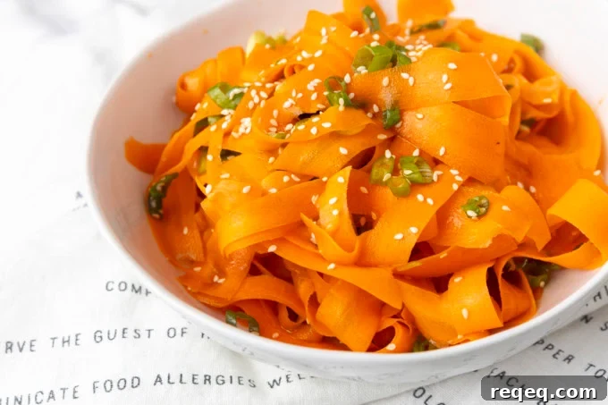 Crisp Asian Carrot Salad with Sesame Ginger Dressing 4 carrot ribbon salad in a white bowl