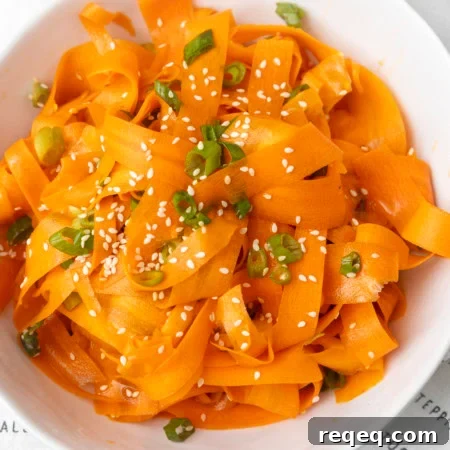 Crisp Asian Carrot Salad with Sesame Ginger Dressing 5 carrot ribbon salad in a white bowl