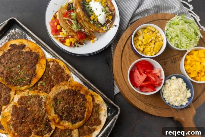 smash tacos on a pan and on stacked plates with toppings in bowls