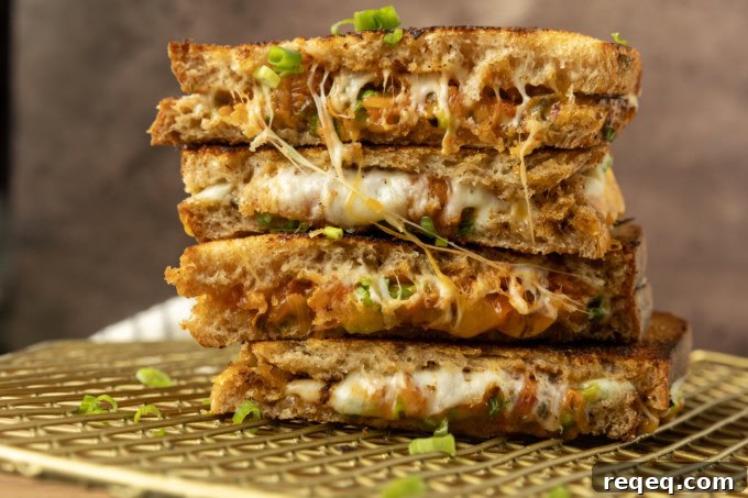 Kimchi Grilled Cheese Sandwich Recipe for Crispy, Spicy Melt 2 stack of kimchi grilled cheese on a cooling rack.