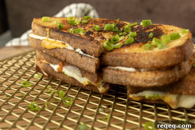 Kimchi Grilled Cheese Sandwich Recipe for Crispy, Spicy Melt 3 stack of kimchi grilled cheese on a cooling rack.
