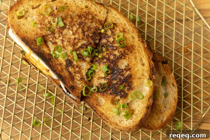 Kimchi Grilled Cheese Sandwich Recipe for Crispy, Spicy Melt 4 stack of kimchi grilled cheese on a cooling rack.