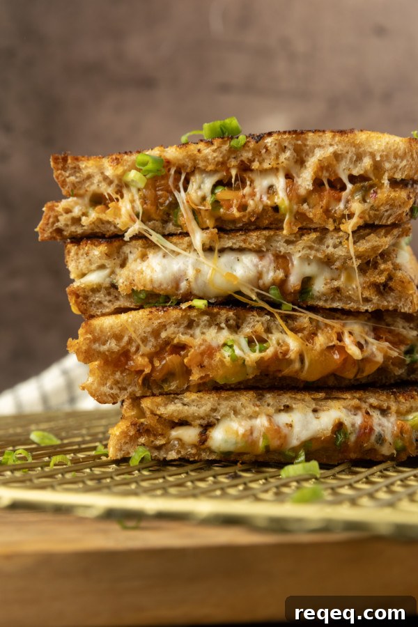 Kimchi Grilled Cheese Sandwich Recipe for Crispy, Spicy Melt 5 stack of kimchi grilled cheese on a cooling rack.