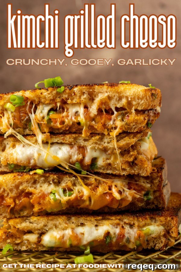 Kimchi Grilled Cheese Sandwich Recipe for Crispy, Spicy Melt 7 stack of kimchi grilled cheese with a lot of melted cheese pulling out of it and text overlay describing the photo