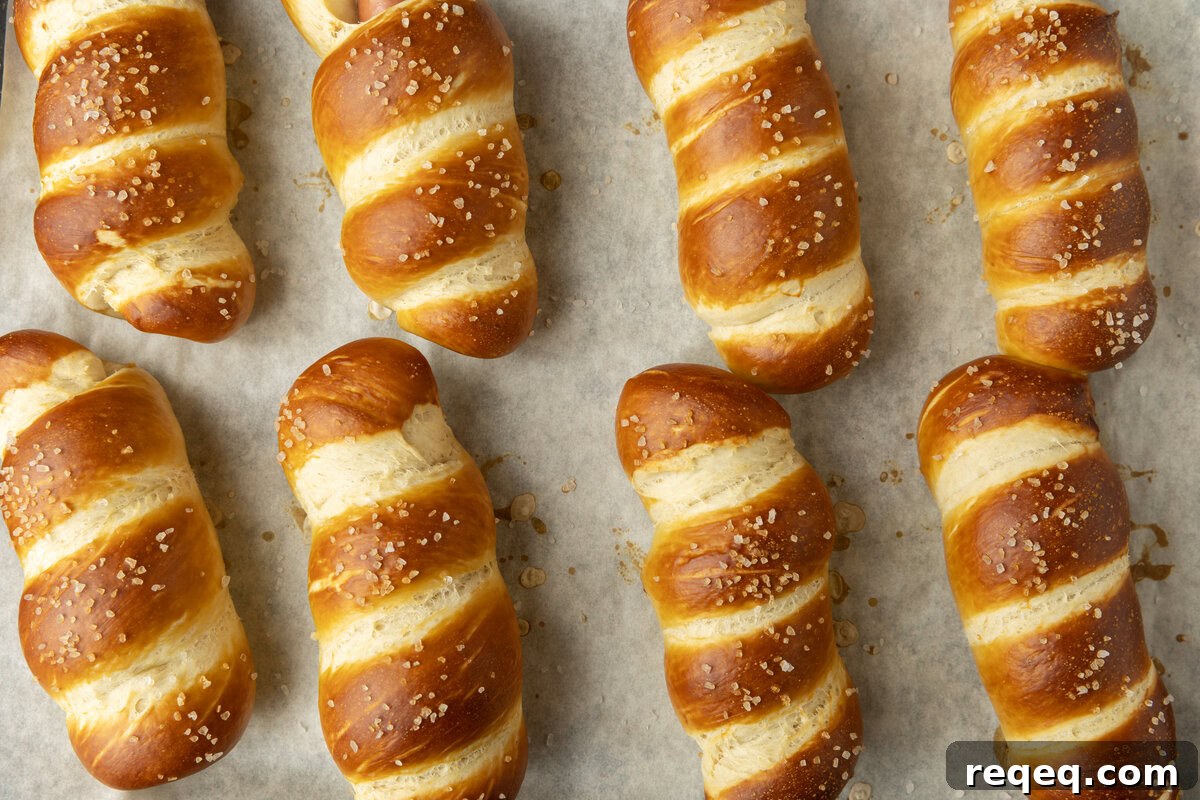 How to Make Pretzel Dogs at Home: Soft, Chewy Snack Recipe 3 pretzel dogs on parchment paper on a pan