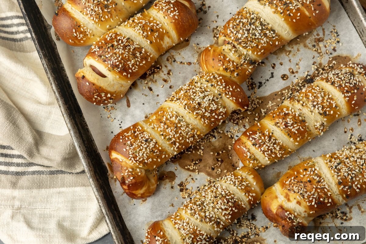 How to Make Pretzel Dogs at Home: Soft, Chewy Snack Recipe 4 pretzel dogs on parchment paper on a pan