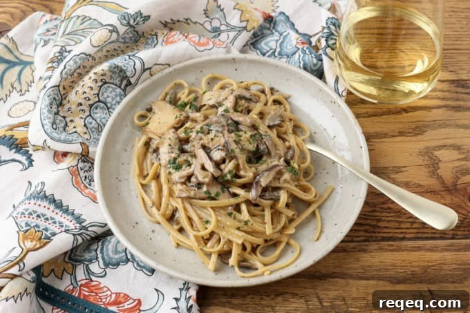 Creamy Miso Mushroom Pasta with Garlic and Thyme 4 miso mushroom pasta with a fork on a plate with a glass of white wine