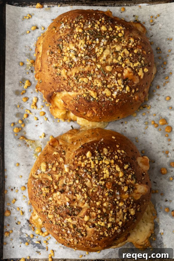 Rosemary Parmesan Artisan Bread Recipe for Crispy Crust and Flavor 6 two loaves of rosemary parmesan bread on a parchment lined sheet pan