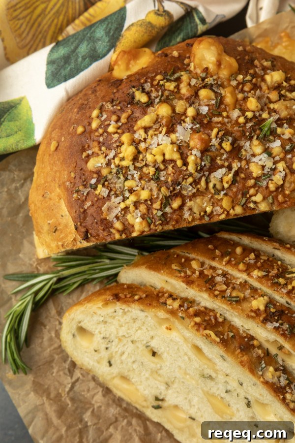 Rosemary Parmesan Artisan Bread Recipe for Crispy Crust and Flavor 8 partially sliced one hour rosemary parmesan bread on parchment paper
