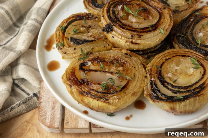 Crispy Oven-Roasted Onions with Garlic and Herbs 2 baked onions on a plate
