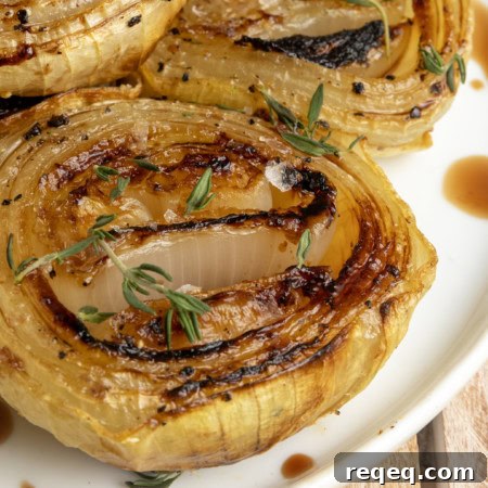 Crispy Oven-Roasted Onions with Garlic and Herbs 8 baked onions on a plate