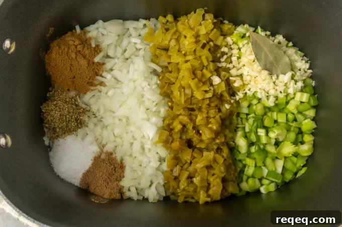 Slow-Cooker White Bean Chicken Chili Recipe for Comforting Weeknight Meals 4 chicken breast, celery, onion, garlic, diced chiles, spices, and bay leaf in a slow cooker for white bean chicken chili