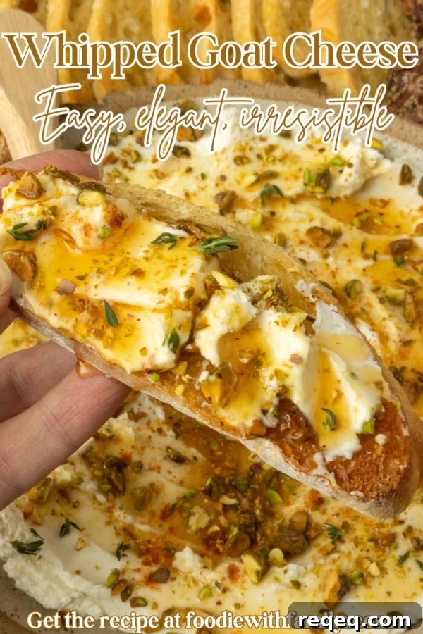 whipped goat cheese appetizer in a pottery bowl with crostini, salami, and grapes and text overlay describing the photo