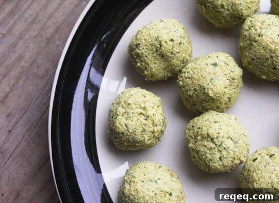 falafel balls before frying on a black and white plate