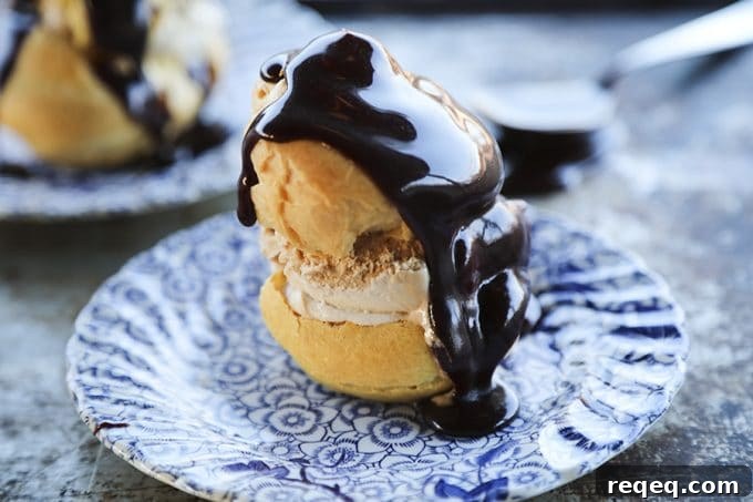 Classic French Profiteroles Recipe: Cream-Filled Choux Pastry Dessert 2 Homemade Cream Puffs filled with ice cream and topped with hot fudge sauce for profiteroles.