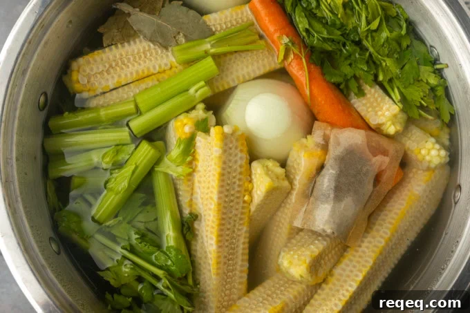 Corn Stalk Care and Harvest Guide: Tips for Stronger Plants 3 corn cobs and vegetables in a stockpot to make corn stock
