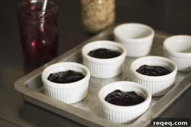Ramekins topped with make-ahead crisp topping ready for baking.